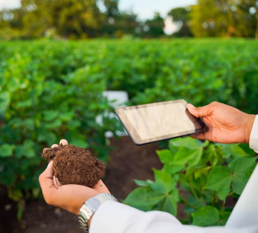 Syngenta | Person holding soil in left hand and tablet in right hand